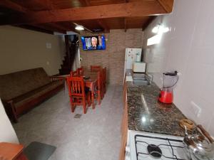 a kitchen and dining room with a table and a counter top at Del muelle in Miramar