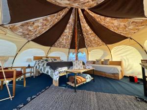 a room with a tent with a bed and a table at La Colmena Glamping in El Rosario +17 photos