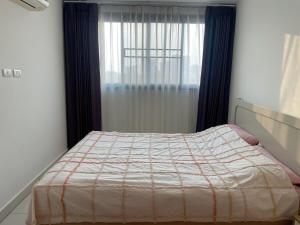 a bedroom with a bed with a window and a bedspread at Paradise Now in Jomtien Beach +22 photos