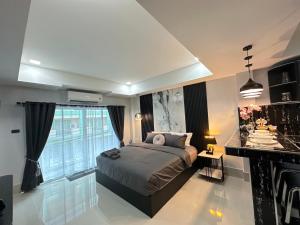 a bedroom with a bed and a large window at VIRAPLACe2# in Pattaya