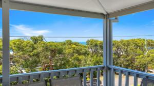 a view of the ocean from the porch of a house at 'Killy Beach House' by HolidayCo in Killcare
