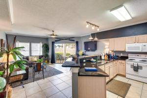 an open kitchen and living room with a couch at Destin Ground-Level Condo w/ Private Beach Access in Destin