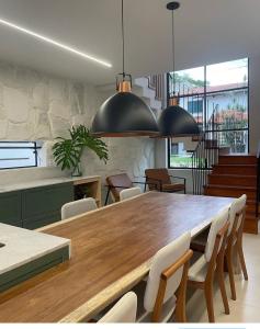a dining room with a large wooden table and chairs at Casa Paraíso in Pirenópolis