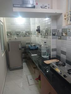 a kitchen with a counter and a refrigerator at Rémi Villa White Town in Puducherry