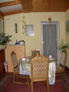 a dining room with a table and two chairs at Pension Kroth an der Mosel in Briedel +7 photos