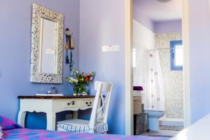 a bedroom with a sink and a mirror and a bed at Eva's House in Stroumbi +37 photos
