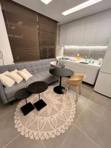 a living room with a couch and a table at Chaleville barrinha in Barrinha