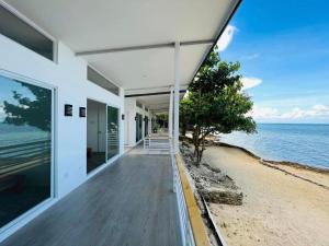 an empty house with a view of the ocean at Mandala Beach Cebu by Hiverooms in Medellin