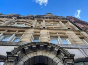 a tall building with an archway in front of it at McCartney Place at the Cavern Quarter in Liverpool