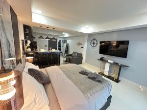 a bedroom with a bed and a tv on a wall at VIRAPLACe3# in Pattaya
