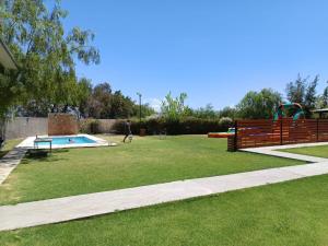 a park with a swimming pool and a playground at Rincón del Sol en Albardón in Albardón