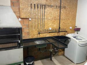 a kitchen with a sink and a trash can at Casa na praia em Torres my house in Torres in Torres +29 photos