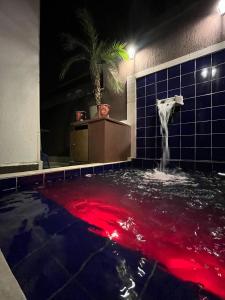 a swimming pool with a horse in the water at Casa Ferry Piscina Privativa e Hidro 300m da Praia in Praia Grande