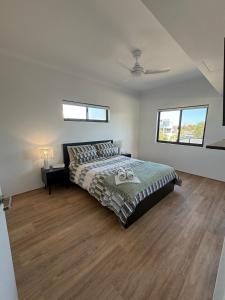 a bedroom with a bed and two windows at Shoreline Bliss in South Beach