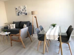 a living room with a table and a couch at Departamento JACARANDA con cochera in Bahía Blanca
