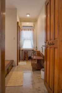 a room with a door and a window and a chair at Diwa Siargao Eco-House in General Luna +25 photos