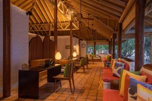 a lobby with a lot of chairs and tables at Cinnamon Dhonveli Maldives - Complimentary Speedboat Return for 2 pax on 7 nights or more stays valid to 31 Oct 2027 & up to 2 kids stay free in North Male Atoll