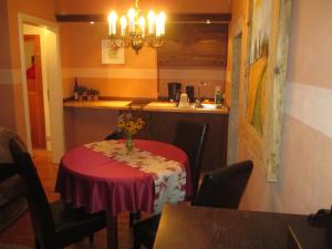 uma cozinha com uma mesa com uma toalha de mesa vermelha em Stadtoase em Meissen
