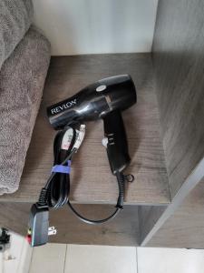 a hair dryer sitting on a wooden table at Magnífica habitación rodeada de arte en Centro Histórico in Mexico City