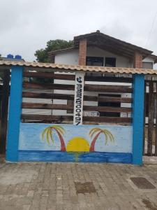 a building with a painting of palm trees on it at Hostal Brisa y Mar in Arboletes