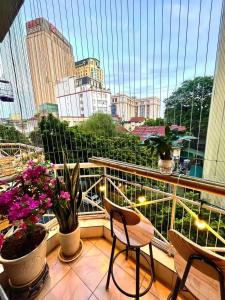 a balcony with chairs and a view of a city at Charm Home 2 in Hanoi