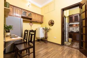 a kitchen with a refrigerator and a table and chairs at Charm Home 2 in Hanoi