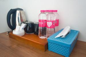 two bottles of water sitting on a wooden table at M Bali 2 in Ngaglik