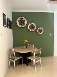 a dining room table with two chairs and two mirrors at Sampai Town Hotel in Adi Sutjipto