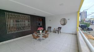 a patio with a table and chairs on a balcony at Casa de Alto Padrão com Area de Lazer e Piscina - Cop 30 in Belém
