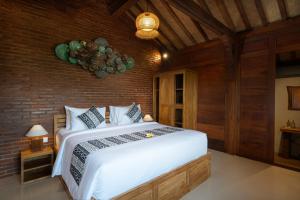Postel nebo postele na pokoji v ubytování Oemah Joglo 2 Ubud
