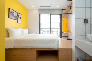 Postel nebo postele na pokoji v ubytování Wilque Hotel Hanoi