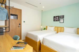 Postel nebo postele na pokoji v ubytování Wilque Hotel Hanoi