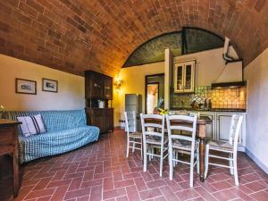 a living room with a couch and a table and chairs at Agriturismo Tenuta Quarrata Santo Pietro Belvedere in Ripoli