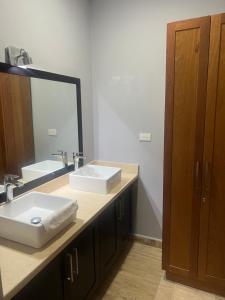 a bathroom with two sinks and a large mirror at Laguna beach in Sosúa +12 photos