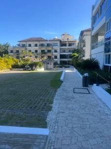a walkway in the middle of a courtyard with buildings at Laguna beach in Sosúa