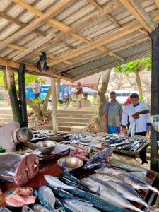 a group of people standing around a table full of fish at Conch Villa- 3 Min walk to the beaches in Tangalle