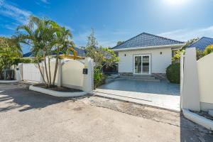 a white house with a palm tree in a driveway at V174 Great Base 2 Explore Phuket Everting you Need in Phuket Town