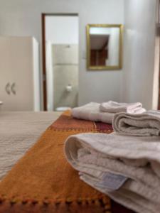 two towels sitting on a bed in a room at El marinero puerto pirámides in Puerto Pirámides