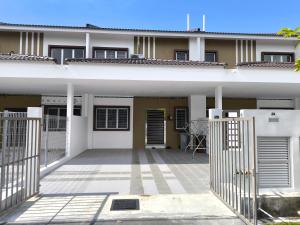 a house with a gate in front of it at Putera Indah Homestay Batu Pahat 13 pax by Ngio in Batu Pahat