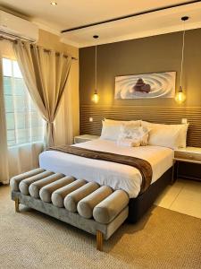 a bedroom with a large bed with a large window at LIVE-INN LUXURY SUITES in Mahalapye