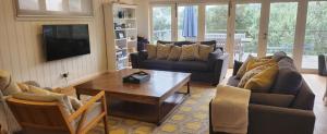 a living room with couches and a coffee table at Coastal White House in Point Lonsdale +5 photos
