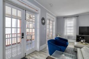 a living room with a blue chair and a couch at 20 Hypolita Street in St. Augustine