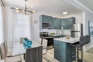 a kitchen with blue cabinets and a table with chairs at 20 Hypolita Street in St. Augustine