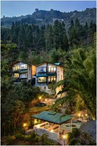 a large house on a hill with lights at Summit Norling Resort & Spa in Gangtok