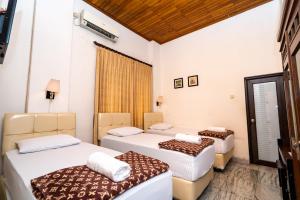 Ένα ή περισσότερα κρεβάτια σε δωμάτιο στο D Ajenk Boutique Guesthouse