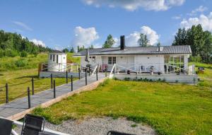 a house with a playground in front of it at Lovely home in Ringstad in Kil +12 photos