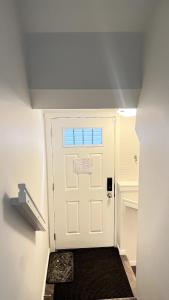a white door with a black mat in front of it at Private luxury Guest Suite in Winnipeg, Separate Entrance and Free Parking in Winnipeg +9 photos