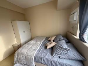 a bedroom with a bed with two pillows on it at Amoore Avida Tower 2 in Cagayan de Oro
