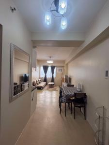 a living room with a table and a dining room at Amoore Avida Tower 2 in Cagayan de Oro +4 photos