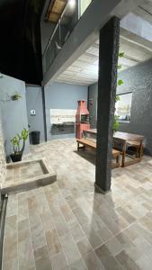 a living room with a table and a piano at Casa Beira Mar in Santa Cruz Cabrália